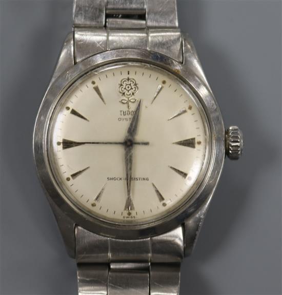 A gentlemans stainless steel Tudor Oyster manual wind wrist watch, on a stainless steel Rolex bracelet.